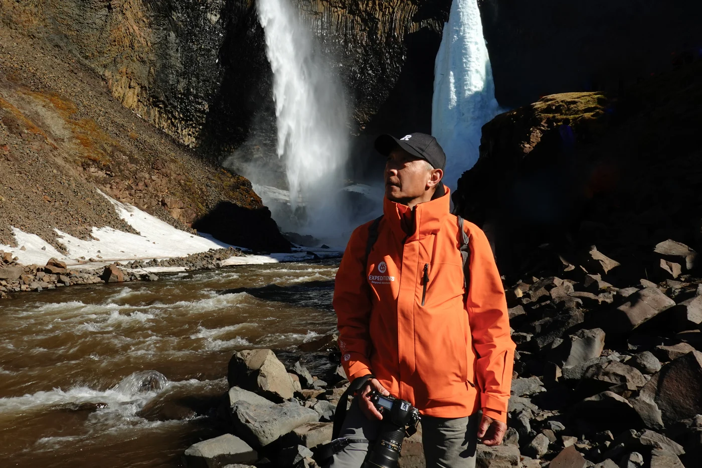 Ren Yunping traveling near a waterfall and ice formations.